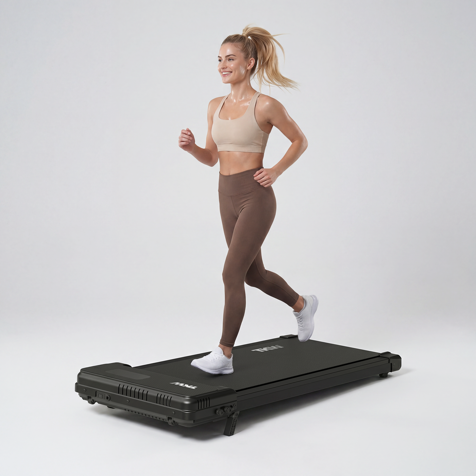 Woman jogging on a TKW walking pad for a light workout at home